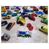 A SMALL COOLER FILLED WITH TOY CARS AND HEAVY EQUIPMENT RIGS A SMALL COOLER FILLED WITH TOY CARS AND HEAVY EQUIPMENT RIGS