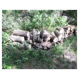 Cascading line of stacked firewood ...