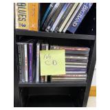Large Collection of Assorted Music CDs with Tall CD Shelf