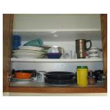 Cupboard filled with dishes and kit...