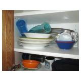 Cupboard filled with dishes and kit...