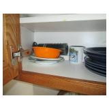 Cupboard filled with dishes and kit...