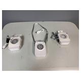 Three Portable Rechargeable Neck Fans. USB Charging Cable Included. The fans also have a clip and will stand on flat service.
