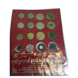 A mix of different coins and stamps, including a special silver German coin from 1874. A mix of different coins and stamps, including a special silver German coin from 1874.