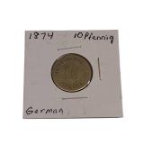 A mix of different coins and stamps, including a special silver German coin from 1874. A mix of different coins and stamps, including a special silver German coin from 1874.
