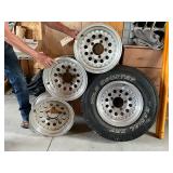 4 - 15" Alum Rims, 1 with Wild Country Radial XRT 235/75R15 4 - 15" Alum Rims, 1 with Wild Country Radial XRT 235/75R15