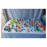 Mixed vintage Fisher-Price toys including vehicles, figures, and accessories