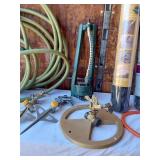 Garden Tools and Supplies including Hose Reel, Weed Barrier, and Sprinklers