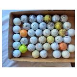 Golf equipment set including Johnny Miller Signature irons, wooden drivers, and a bag with assorted golf balls