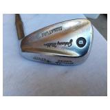 Golf equipment set including Johnny Miller Signature irons, wooden drivers, and a bag with assorted golf balls