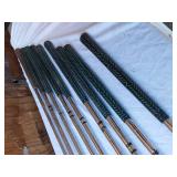 Golf equipment set including Johnny Miller Signature irons, wooden drivers, and a bag with assorted golf balls