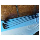 Golf equipment set including Johnny Miller Signature irons, wooden drivers, and a bag with assorted golf balls