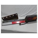 Tail light assembly with bracket and reflective strip