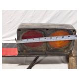 Tail light assembly with bracket and reflective strip
