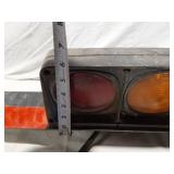 Tail light assembly with bracket and reflective strip