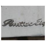 Assorted Automotive Parts including Broken Pontiac Emblem, Guide R8-50 Light, and Various Lenses