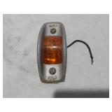 Assorted Automotive Parts including Broken Pontiac Emblem, Guide R8-50 Light, and Various Lenses