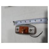 Assorted Automotive Parts including Broken Pontiac Emblem, Guide R8-50 Light, and Various Lenses