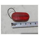 Assorted Automotive Parts including Broken Pontiac Emblem, Guide R8-50 Light, and Various Lenses