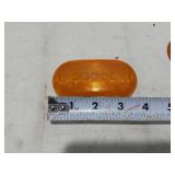 Assorted Automotive Parts including Broken Pontiac Emblem, Guide R8-50 Light, and Various Lenses