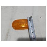Assorted Automotive Parts including Broken Pontiac Emblem, Guide R8-50 Light, and Various Lenses