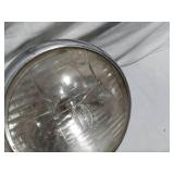 Assorted Automotive Parts including Broken Pontiac Emblem, Guide R8-50 Light, and Various Lenses
