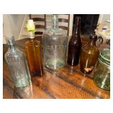 Collection of Vintage Glass Bottles with Embossed Text Collection of Vintage Glass Bottles with Embossed Text