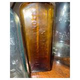 Collection of Vintage Glass Bottles with Embossed Text Collection of Vintage Glass Bottles with Embossed Text