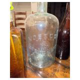 Collection of Vintage Glass Bottles with Embossed Text Collection of Vintage Glass Bottles with Embossed Text