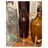 Collection of Vintage Glass Bottles with Embossed Text Collection of Vintage Glass Bottles with Embossed Text