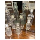 Vintage Collection of 14 French and English Assorted Glass Bottles with Stoppers Vintage Collection of 14 French and English Assorted Glass Bottles with Stoppers