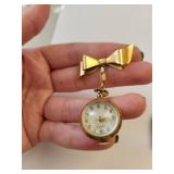 2 Vintage Watches: LGN Silver Tone Wristwatch & Gold Tone Bow Pendant Watch