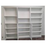 Three White Adjustable Shelving Units