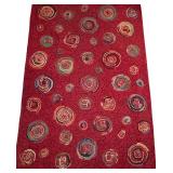 Red Area Rug with Circular Pattern
