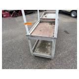 (2) rolling carts: Orange Rubbermaid commercial and Rubbermaid service cart with metal stand on top