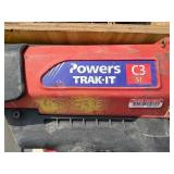 2 Powers Trak-It Gas Fastening tool in cases; battery in one case has a charge. Both fasteners power up