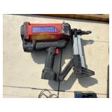 2 Powers Trak-It Gas Fastening tool in cases; battery in one case has a charge. Both fasteners power up