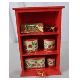 Vintage Red Painted Shelf with Strawberry-Themed Tins and Soap