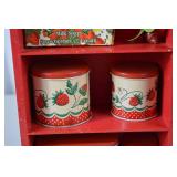 Vintage Red Painted Shelf with Strawberry-Themed Tins and Soap
