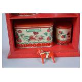 Vintage Red Painted Shelf with Strawberry-Themed Tins and Soap