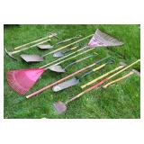 Collection of Garden and Lawn Tools Including Shovels, Rakes, and Axes
