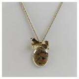Gold Tone Base Metal Locket Necklace with Bow Accent