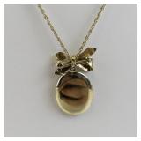 Gold Tone Base Metal Locket Necklace with Bow Accent