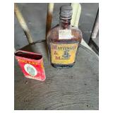 Whisky bottle and Tobacco can
