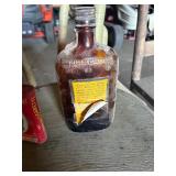 Whisky bottle and Tobacco can
