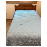 Twin Size Bed with Wooden Headboard and Light Blue Quilt