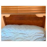 Twin Size Bed with Wooden Headboard and Light Blue Quilt