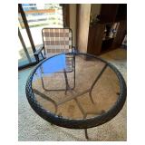 Round Glass Patio Table with Woven Edge and Folding Chair