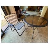 Round Glass Patio Table with Woven Edge and Folding Chair