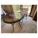 Round Glass Patio Table with Woven Edge and Folding Chair